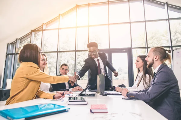 Business Man. Business handshake and business people. African businessman shaking hands with a caucasian woman. smiling african businessman handshaking with young businesswoman in office