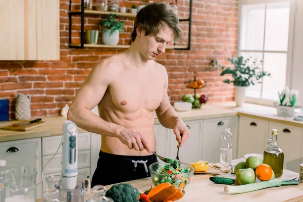 Man preparing delicious and healthy food in the home kitchen on a sunny day.