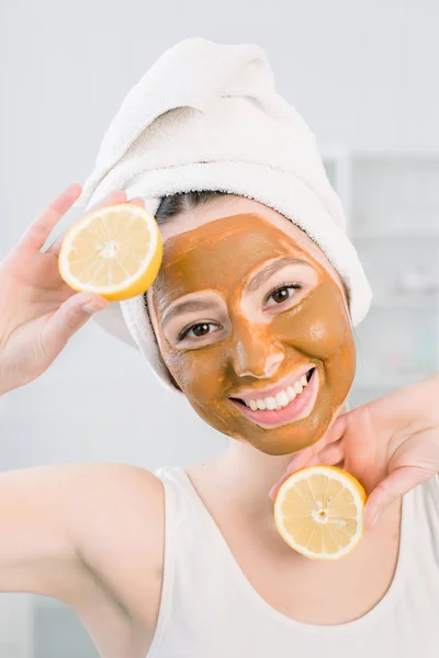 Ung frisk kvinna i spa gör behandlingar och ansikte lera mask. — Stockfoto