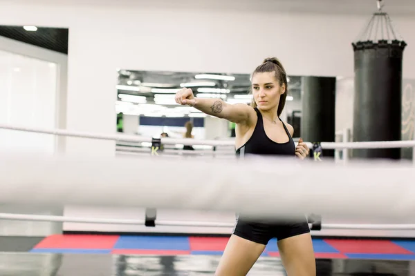 Sexy boxeador femenino caucásico de pie en el ring de boxeo en el gimnasio —  Fotos de Stock