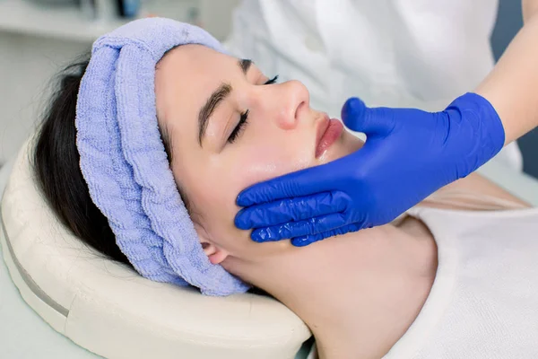 Procedures for face. Beautiful young woman enjoying spa procedures for face at the weekend