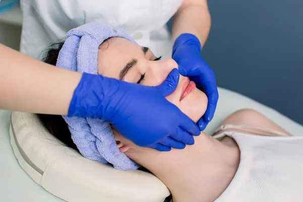 Procedures for face. Beautiful young woman enjoying spa procedures for face at the weekend