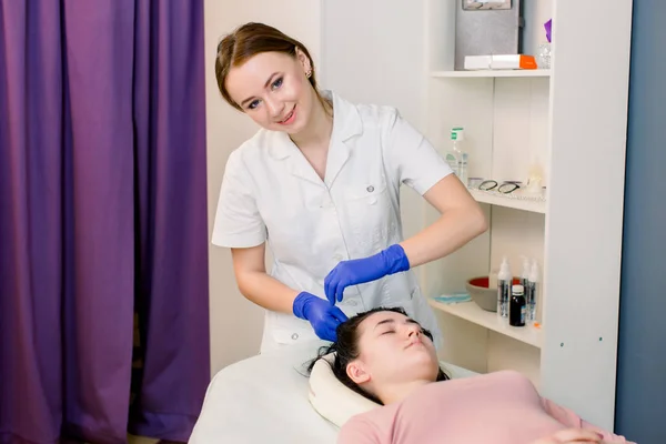 Procedure of mesotherapy. The doctor cosmetologist makes the beauty procedure in womans head. Strengthen hair and their growth.