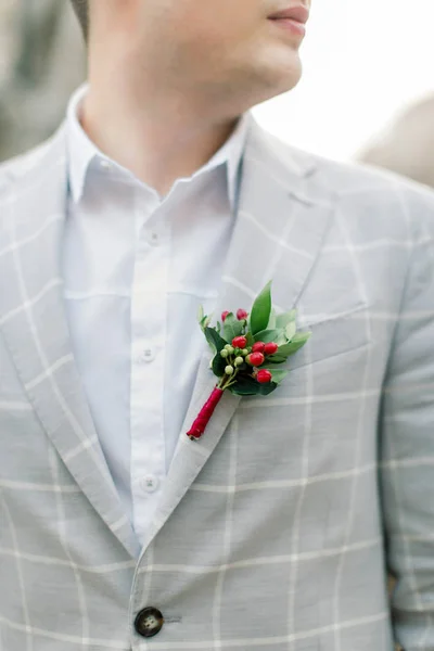 Stylish smiling groom in a gray jacket, posing outdoors, standing on the stone stairs of the monument in old city center before the wedding ceremony — Stock Photo, Image