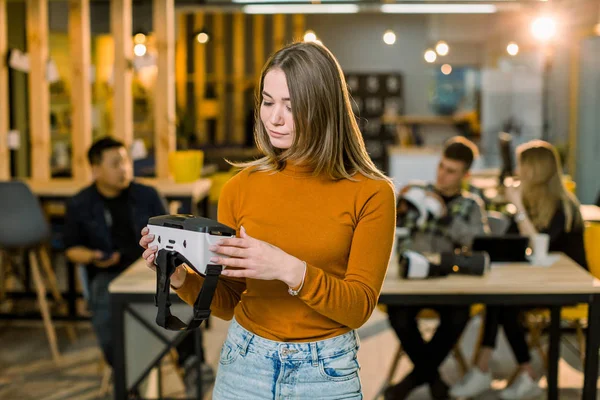 Vidám fiatal nő hozzáigazítva a virtuális valóság headset állva neki dolgozik, irodai pihenni. — Stock Fotó