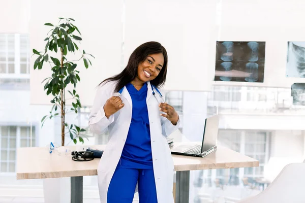 Cute young African American doctor female with long hair wearing medical uniform having happy expression. Medical and nurse concept — 스톡 사진