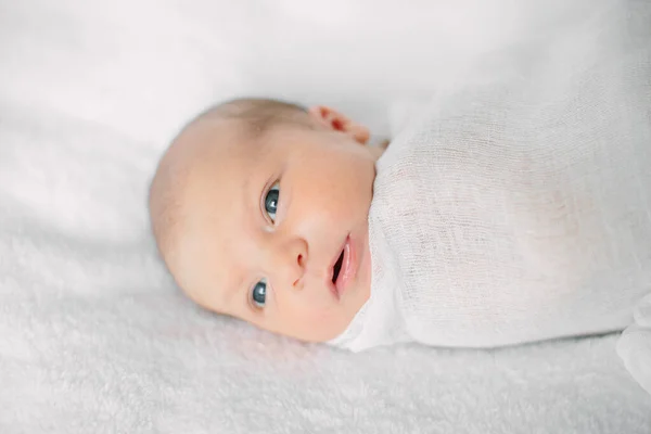 Cute newborn girl sleeping on furry cloth wearing white headband — Stock Photo, Image