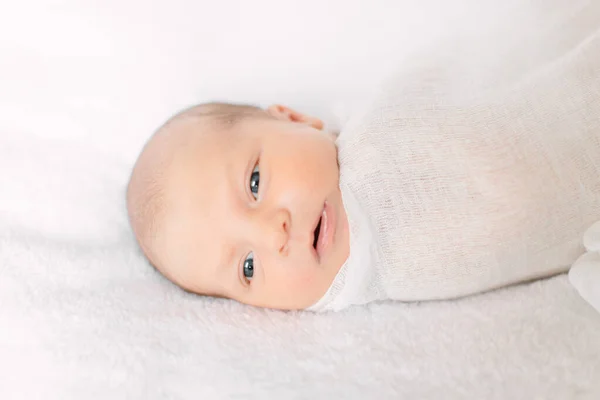 Cute newborn girl sleeping on furry cloth wearing white headband — Stock Photo, Image