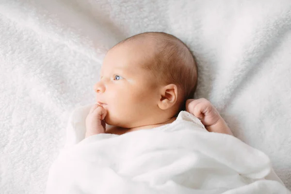 Cute newborn girl sleeping on furry cloth wearing white headband — Stock Photo, Image