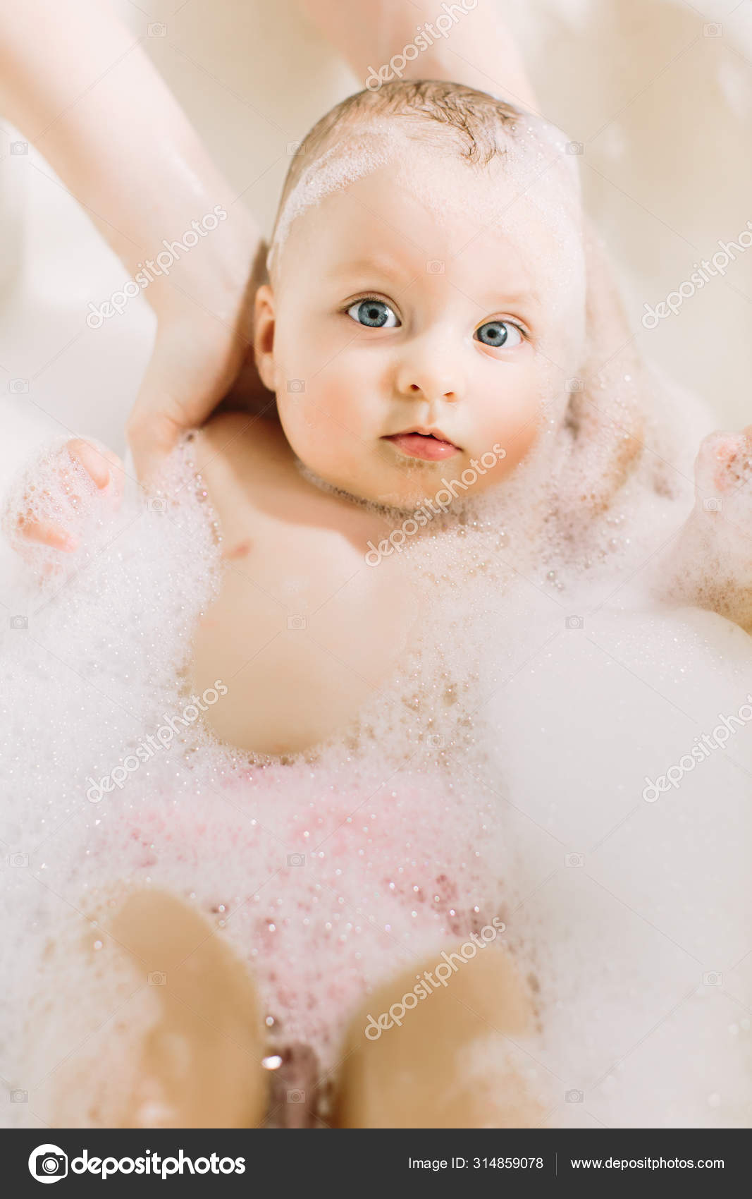 Happy little baby a swimming in the bathroom.Portrait of baby bathing