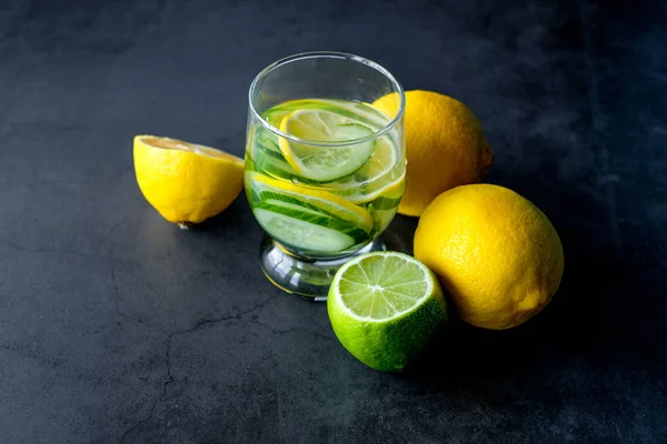 Yellow lemon and lime for fresh lemonade on black background