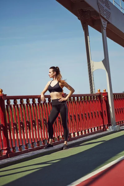 Fitness sporty woman with headphones during outdoor exercises workout. Beautiful fit Girl in sport wear. Fitness model outdoors. Weight Loss. Healthy lifestyle. Sporty healthy female.