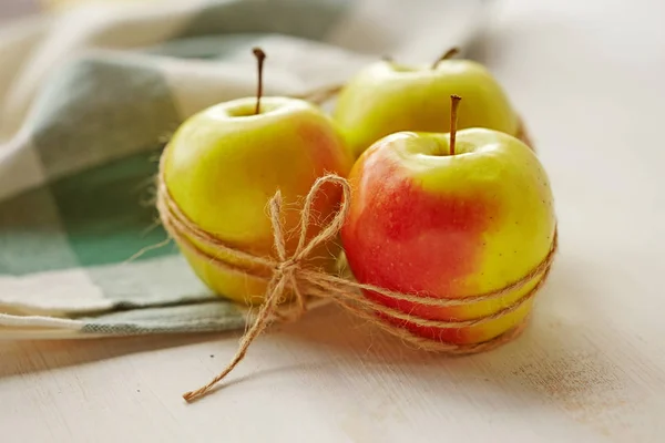 Apples over white wooden table. Beautiful styled organic autumn fruits. Thanksgiving background. Healthy diet eating.