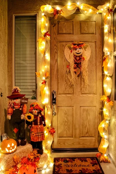 The front door of a home decorated for the fall season.