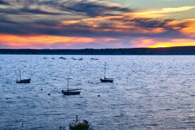 Coast Maine ile ön planda okyanus boyunca ufukta güneş ayarı.