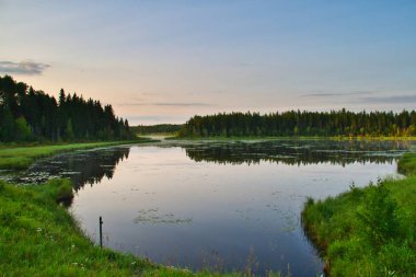 A lake in Prince Albert National Park in the early morning hours. clipart