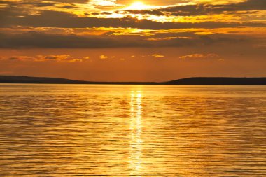 The sun setting over Waskesiu Lake in Prince Albert National Park of Canada. clipart