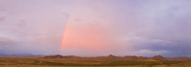 A panorama of an Arizona monsoon with a rainbow clipart