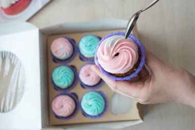 Cupcake cupcakes, flatlay bir kutu arka plan üzerine bir kaşık elinde