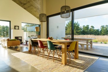 Bahçe havuzu ve ahşap güvertesi olan modern bir ev.