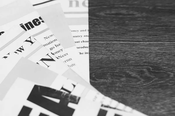 Newspapers and magazines. Daily paper with news on wooden table. Pages with text, articles and headlines. Concept for business and information, press and media. Close up, side view