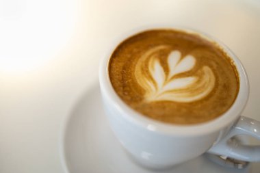 Süt köpük kalp ile sıcak kahve latte beyaz fincan yakın