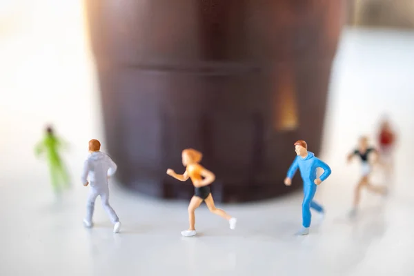 Food and sport concept. Close up of group of runner miniature fi