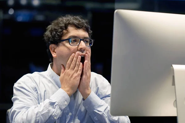 A man in stress in front of a computer. Poor economy concept. Face expression, emotion. Body And Health Care Concept.