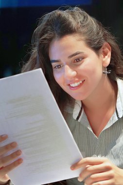 Otel Yöneticisi. Yazılı olarak iyi haber zevk bir kadın-Resepsiyon çalışan mutlu Bayan. Bir euphoric kız mutlu bir yazılı mektupta iyi haber okuma, bir kredi onaylama, yetiştirme işini sonra.