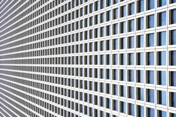 The outgoing perspective of the windows of the facade of a modern building. Glass grey square Windows of modern city business building skyscraper. Windows of a building, texture.