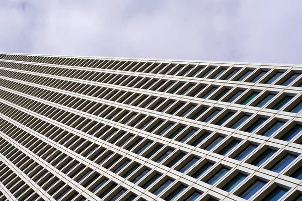 The outgoing perspective of the windows of the facade of a modern building. Glass grey square Windows of modern city business building skyscraper. Windows of a building, texture.