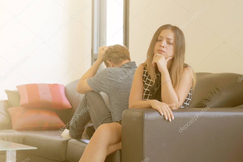 Serious sad woman thinking over a problem, man sitting aside, end of long-term relations, an alcoholic, drug addicted partner, poor conflict management skill. Toning