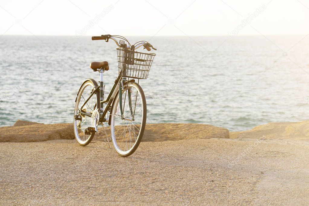 Bicycle parked on beach. Retro bike near the sea. Bike on the background of the sea horizon.