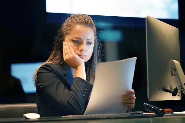 A woman-reception hotel worker reading negative news in letter. Shocked beauty girl business manager received layoff message letter from company feeling surprised. An agitated girl without joy.