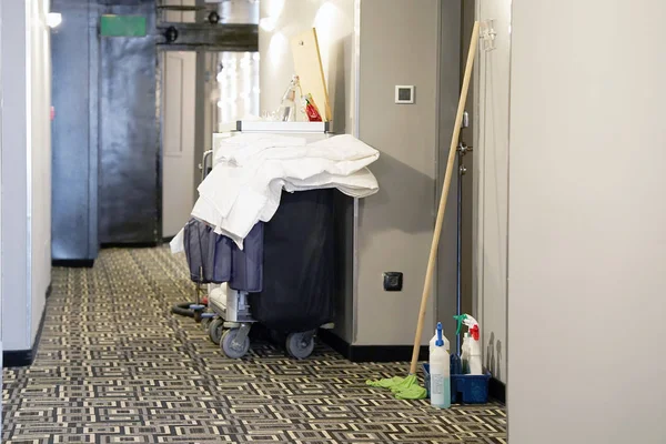 Cleaners trolley with cleaning equipments at hotel