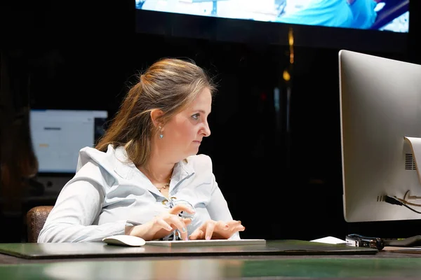 Hotel manager. A woman-reception worker makes out an order for booking a room. Profile shot of attractive executives at the reception of the hotel. The concept of service.