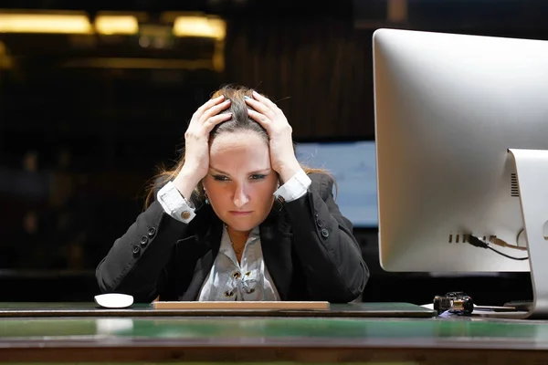 Hotel manager. A woman-reception made a mistake in the bill, shocked sitting in front of the monitor of computer. Funny face expression emotion feelings problems reaction, stress, fear