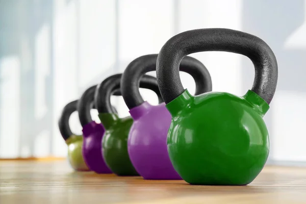 Colorful kettlebells in gym — Stock Photo, Image