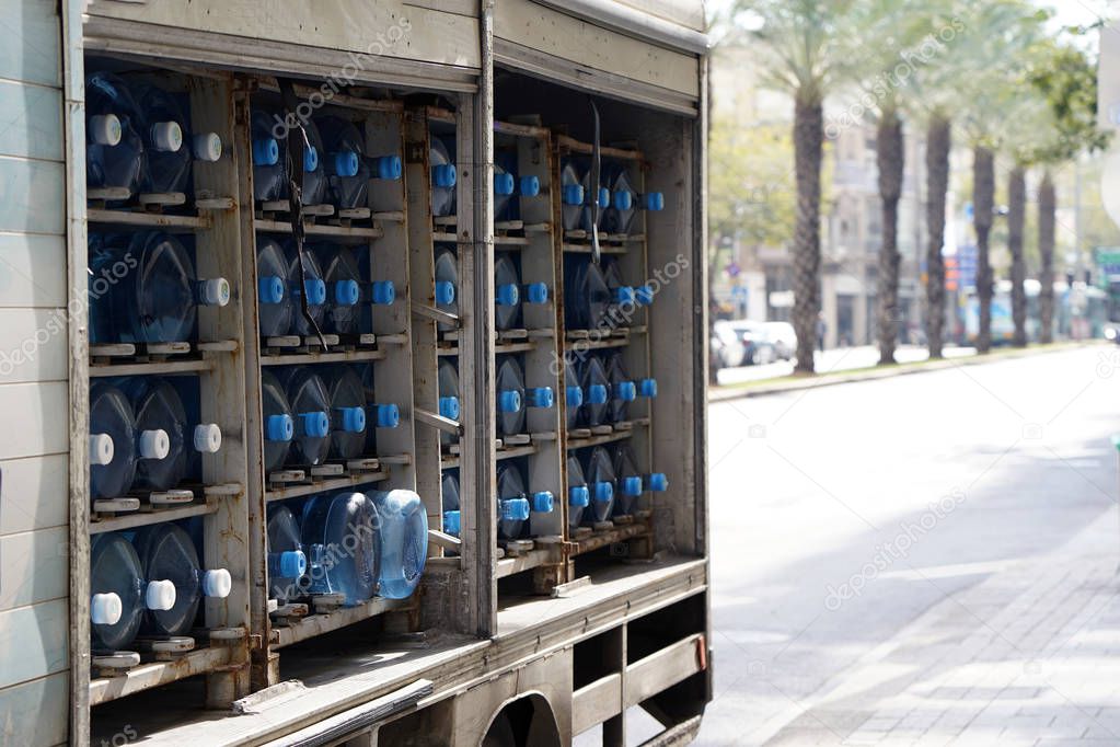 Many water container in a car. Car body with potable water bottles