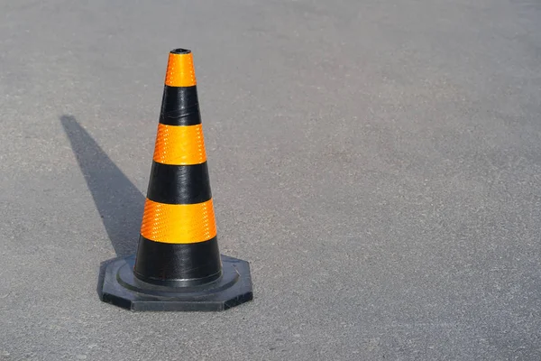 Road cone on the asphalt. Red caps on the road