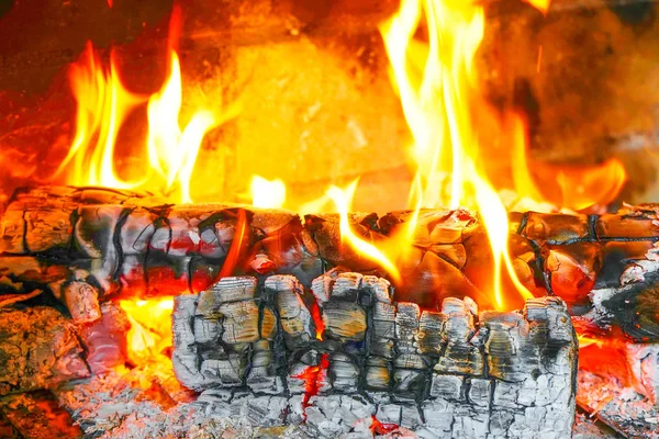 close-up of burning logs in the fireplace