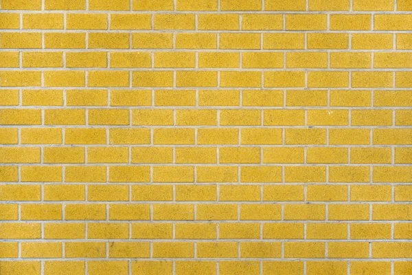 Gele bakstenen muur achtergrond — Stockfoto