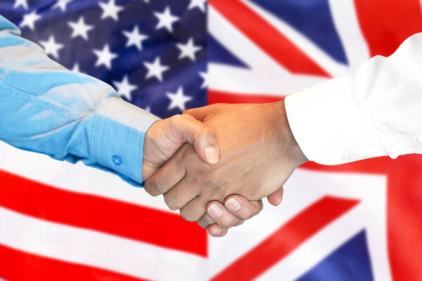 handshake on United Kingdom and USA flag background.