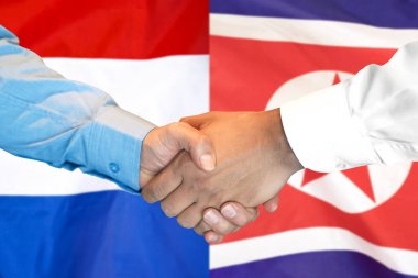 Kuzey Kore ve Hollanda bayrak arka plan üzerinde el sıkışma.