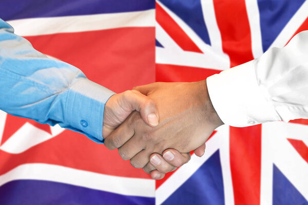 handshake on North Korea and UK flag background.