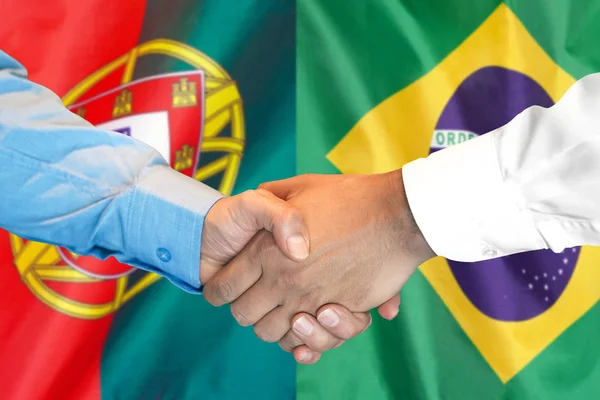 Handskakning om Portugal och Brasilien flagga bakgrund. — Stockfoto