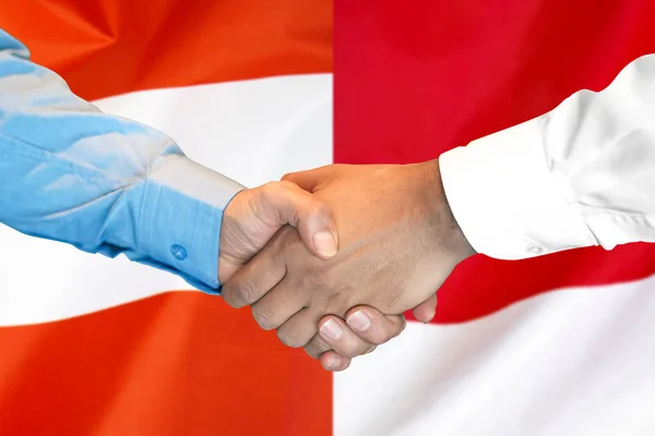 Stretta di mano sullo sfondo della bandiera Austria e Monaco . — Foto Stock