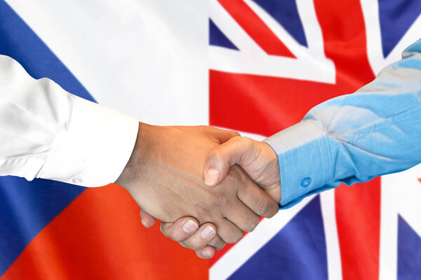 handshake on Czech Republic and UK flag background.