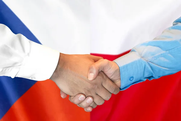 Рукопожатие на фоне флага Чехии и Польши . — стоковое фото