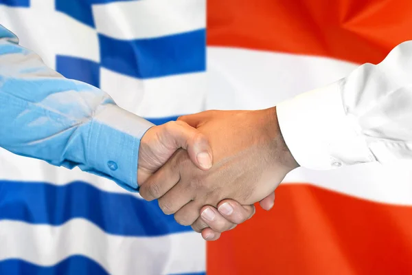 握手希腊和奥地利国旗背景. — 图库照片